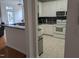 Functional kitchen with neutral tile flooring, featuring white appliances and cabinets, ideal for home cooking at 4502 Pale Moss Dr, Raleigh, NC 27606