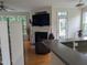 Inviting living room with fireplace and large TV, seamlessly connected to the kitchen, perfect for relaxation at 4502 Pale Moss Dr, Raleigh, NC 27606