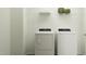 Laundry room with modern washer, dryer, and storage space on top shelf at 525 Morning Light Dr # 31, Angier, NC 27501