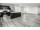Bright open-concept kitchen and living space with stainless steel appliances and grey flooring at 58 Furley St, Sanford, NC 27330