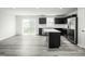 Open concept kitchen and living space with stainless steel appliances and grey flooring at 58 Furley St, Sanford, NC 27330