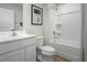 Contemporary bathroom with clean white vanity, shower-tub combination, and modern fixtures at 62 Furley St, Sanford, NC 27330