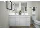 Well lit bathroom featuring a large vanity with dual sinks, modern fixtures, and a toilet at 62 Furley St, Sanford, NC 27330