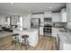 Contemporary kitchen with a large island, stainless steel appliances, and an adjacent living area at 62 Furley St, Sanford, NC 27330