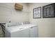 Efficient laundry room with modern washer and dryer, ample storage, and convenient stain removal guide at 62 Furley St, Sanford, NC 27330