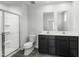 This modern bathroom features double sinks, sleek vanity and shower with glass door at 66 Furley St, Sanford, NC 27330