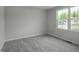 The bedroom offers natural light, neutral walls, and plush gray carpeting at 66 Furley St, Sanford, NC 27330