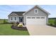 Charming one-story home with gray siding, a two-car garage, and a beautifully landscaped front yard at 66 Furley St, Sanford, NC 27330