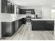 Modern kitchen with stainless appliances, an island, and dark cabinetry with white countertops at 66 Furley St, Sanford, NC 27330
