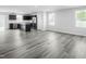 An open concept living space featuring luxury vinyl flooring and access to a modern kitchen at 66 Furley St, Sanford, NC 27330