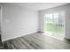 Living room with luxury vinyl floors and lots of natural light from sliding glass door at 66 Furley St, Sanford, NC 27330
