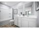 Bright bathroom featuring a double sink vanity, shower over tub, and modern finishes at 700 Port Charlotte Ct, Sanford, NC 27330