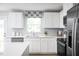 Bright kitchen featuring white cabinets, stainless steel appliances, and a view from over the sink at 700 Port Charlotte Ct, Sanford, NC 27330