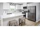 Stylish kitchen featuring an island with seating, stainless appliances, and bright white countertops at 700 Port Charlotte Ct, Sanford, NC 27330