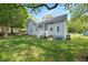 Landscaped backyard with grass and a white porch and awning at 726 Elizabeth Ave, Wake Forest, NC 27587