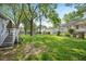 View of spacious backyard with mature trees and partial view of neighboring houses at 726 Elizabeth Ave, Wake Forest, NC 27587