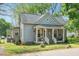 Charming home with a well-maintained lawn, quaint porch, and inviting curb appeal at 726 Elizabeth Ave, Wake Forest, NC 27587
