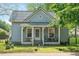 Quaint home with a cozy front porch featuring comfortable seating and charming details at 726 Elizabeth Ave, Wake Forest, NC 27587