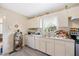 Bright kitchen features white cabinets, laminate countertops, and a stainless steel sink at 726 Elizabeth Ave, Wake Forest, NC 27587