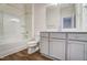 Bright bathroom with a shower-tub combo, white vanity, and vinyl flooring at 743 Parc Townes Dr # 36, Wendell, NC 27591