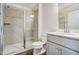 Elegant bathroom featuring a tiled shower with glass door, gray vanity, and modern fixtures at 743 Parc Townes Dr # 36, Wendell, NC 27591