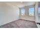 Carpeted bedroom with neutral walls and double windows providing ample natural light at 743 Parc Townes Dr # 36, Wendell, NC 27591