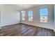 Bright dining room features three large windows, hardwood floors, and a modern chandelier at 743 Parc Townes Dr # 36, Wendell, NC 27591