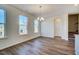 Dining area with ample natural light, hardwood floors, and a stylish chandelier, ready for entertaining at 743 Parc Townes Dr # 36, Wendell, NC 27591