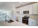 Modern kitchen featuring white cabinetry, stainless steel appliances, and an island with a sink at 743 Parc Townes Dr # 36, Wendell, NC 27591