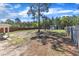 Spacious backyard featuring a fenced yard, mature trees, and an outbuilding at 78 Parkview Ln, Lillington, NC 27546