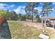 Expansive backyard featuring a storage shed, a covered patio, and ample green space at 78 Parkview Ln, Lillington, NC 27546