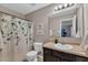 Bathroom with a single sink vanity, toilet, and shower/tub combo with decorative shower curtain at 78 Parkview Ln, Lillington, NC 27546