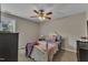 Cozy bedroom featuring neutral walls, plush carpeting, and a decorative ceiling fan at 78 Parkview Ln, Lillington, NC 27546