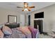 Comfortable bedroom with a ceiling fan, large mirror, and a mounted television at 78 Parkview Ln, Lillington, NC 27546
