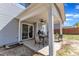 Covered patio featuring a ceiling fan, outdoor seating, and sliding glass doors, seamlessly blending indoor and outdoor living at 78 Parkview Ln, Lillington, NC 27546