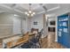 Bright dining room boasts wood floors, coffered ceilings, designer lighting, and a rustic dining table at 78 Parkview Ln, Lillington, NC 27546