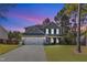 Beautiful two-story home with a two-car garage, well-maintained lawn, and inviting front porch at dusk at 78 Parkview Ln, Lillington, NC 27546
