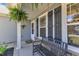 Charming front porch with a cozy bench, hanging fern, and neatly trimmed landscaping, perfect for relaxing outdoors at 78 Parkview Ln, Lillington, NC 27546