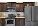 Updated kitchen featuring modern stainless steel appliances and dark cabinets for ample storage and style at 78 Parkview Ln, Lillington, NC 27546