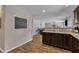 Open-concept kitchen features granite countertops, dark wood cabinets, and a seamless transition to living area at 78 Parkview Ln, Lillington, NC 27546