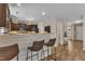 Eat-in kitchen with bar stool seating, stone countertops, and dark brown cabinetry at 78 Parkview Ln, Lillington, NC 27546