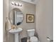 Cozy half bathroom featuring a pedestal sink, framed art, and ample space at 78 Parkview Ln, Lillington, NC 27546