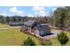 Aerial view of two-story home with screen porch, large, fenced yard, and attached garage with ample parking at 80 Greta Ln, Henderson, NC 27537