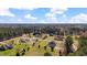 Picturesque aerial shot of houses nestled in a lush, green neighborhood with many mature trees and blue skies at 80 Greta Ln, Henderson, NC 27537
