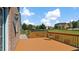 Outdoor deck with wooden railing offers a tranquil view of the backyard and surrounding greenery at 80 Greta Ln, Henderson, NC 27537