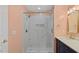 Bathroom with marble shower, gold hardware, and pink walls at 80 Greta Ln, Henderson, NC 27537
