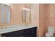 Bathroom with double vanity, gold hardware, and pink walls at 80 Greta Ln, Henderson, NC 27537