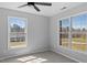 Bright bedroom with neutral walls, two windows, and ceiling fan at 80 Greta Ln, Henderson, NC 27537
