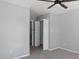 Bedroom with closet, open door, and neutral walls and carpet at 80 Greta Ln, Henderson, NC 27537