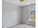 Neutral bedroom with a bright window offering an inviting view and a simple ceiling fan at 80 Greta Ln, Henderson, NC 27537
